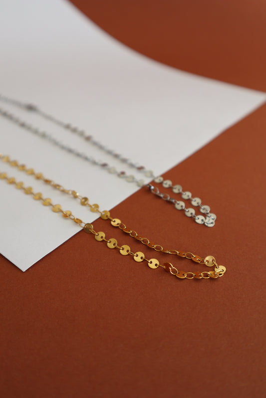 Colar com pequenas medalhas